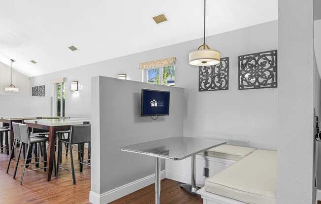 a kitchen with a bar and a dining area with a table and chairs