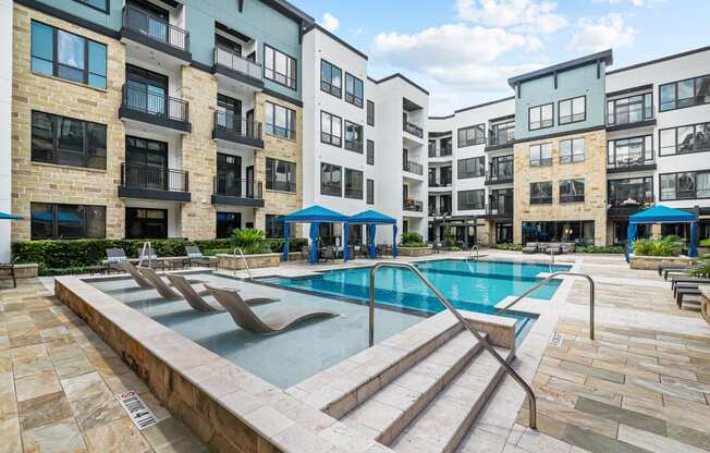 a swimming pool in front of an apartment building