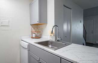 The Willows Apartments kitchen with a sink and white counter tops