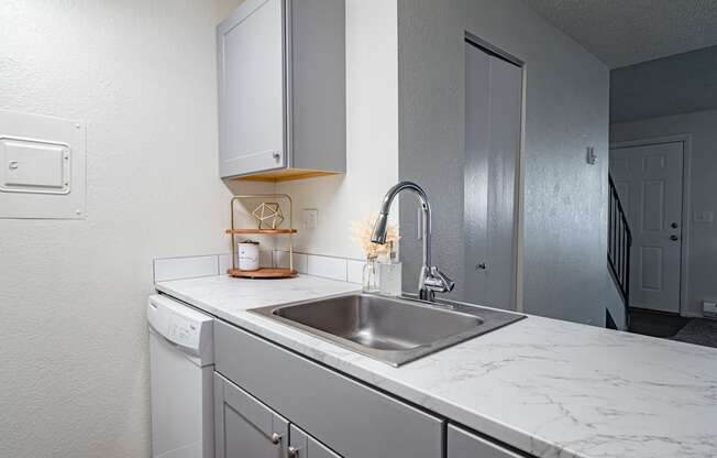 The Willows Apartments kitchen with a sink and white counter tops