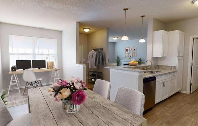 a dining room and kitchen with a desk and computer