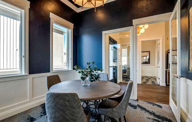 A dining room with a table and chairs.