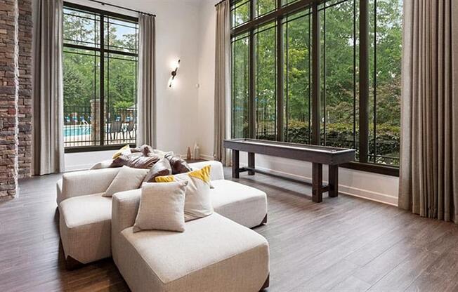 a living room with a couch and a table at Trails at Short Pump Apartments, Virginia