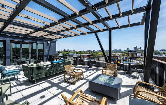A patio with a table and chairs under a roof.