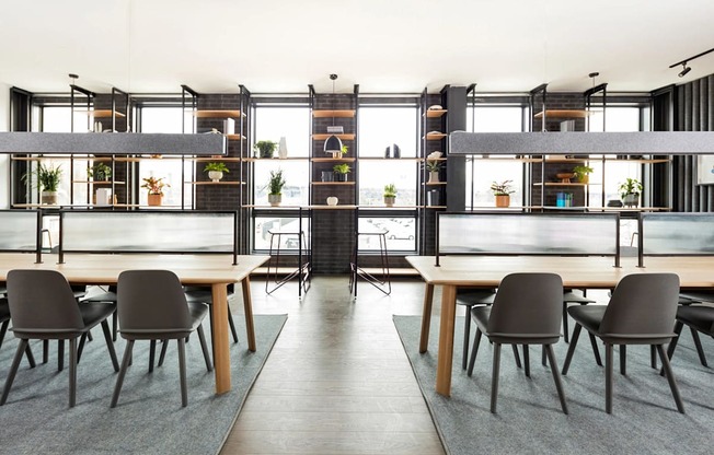 A modern dining room with a long table and chairs.