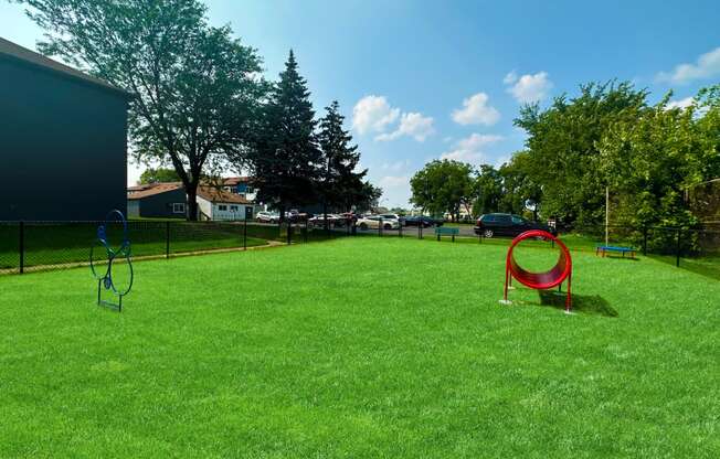 a large grassy area with a playground