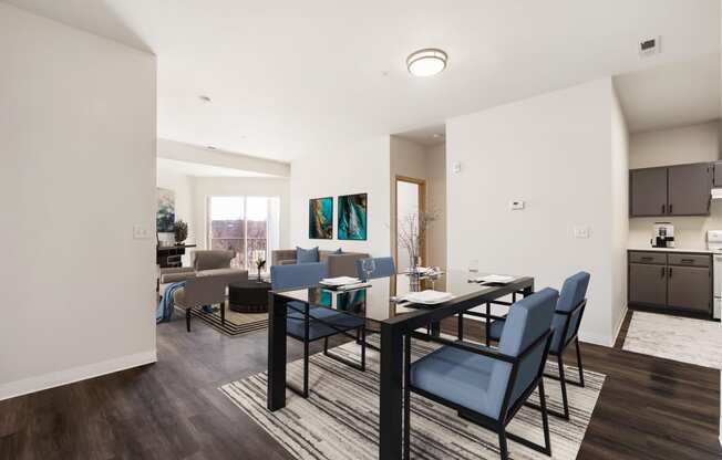 a dining area with a table and chairs and a kitchen in the background.at Shoreline Village, Washington