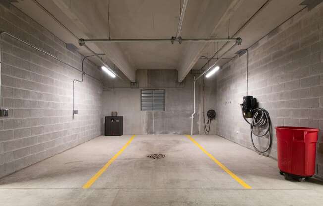 a large storage room with a red bucket in the middle of it