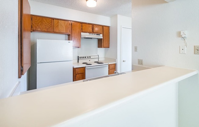 Unit Kitchen with White Appliances at Heritage Square Apartments in Waco, TX