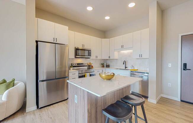 a kitchen with white cabinets and a large yellow bowl on the counter
