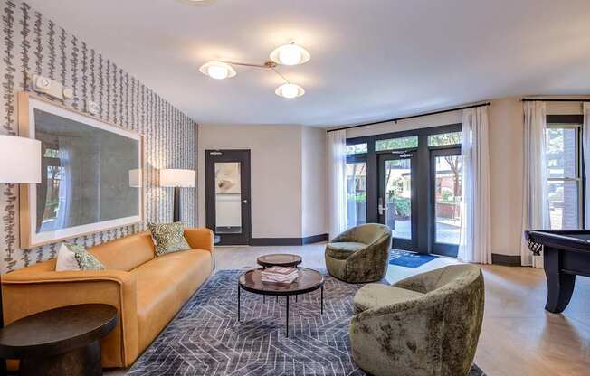 A lounge with a sofa, armchairs, and a coffee table.