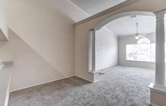 Large and bright living rooms with archways at Turnberry Isle Apartments in Dallas, TX.