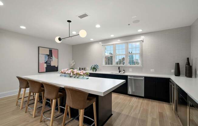 A modern kitchen with a large island and bar stools.