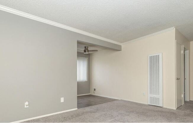 an empty living room with a door to a closet at Villa La Paz Apartments, California