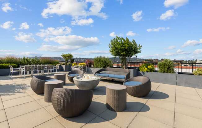 a seating area on the roof of a building with tables and chairs