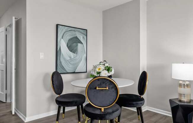 a dining room with a table and four chairs