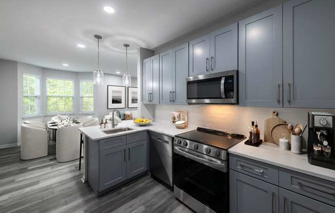 a kitchen with gray cabinets and a white counter top