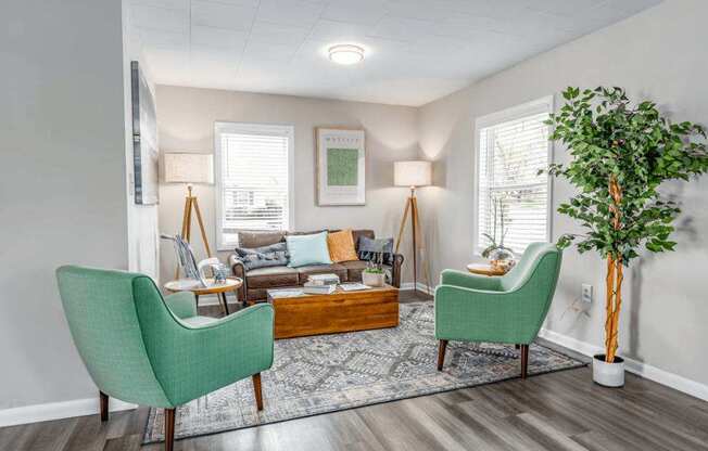 A living room with a green chair and a wooden coffee table.