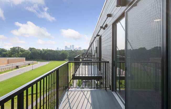 a balcony with a view of the city in the distance