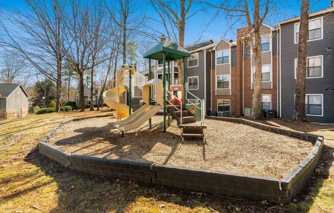 the playground is in front of the apartments