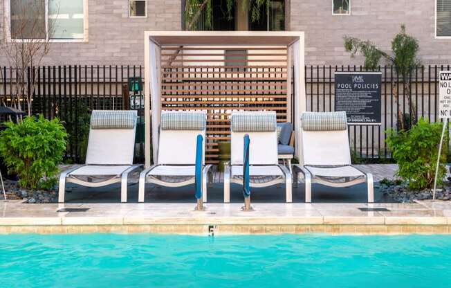 A pool with a sign that says pool policies.