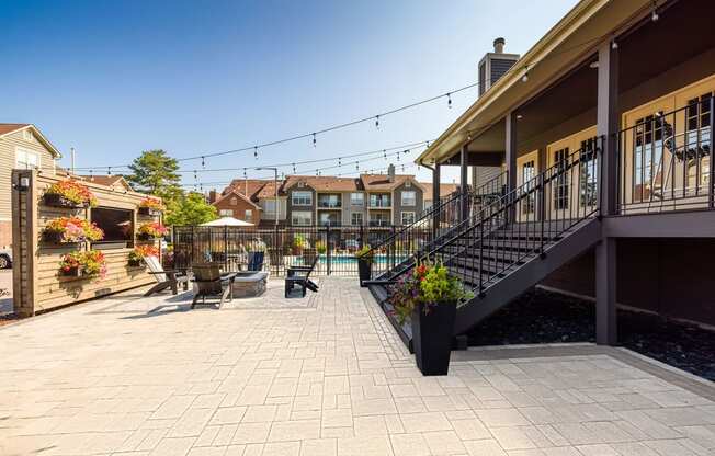 a patio with tables and chairs and a pool