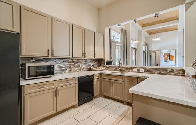 a kitchen with white cabinets and a counter top and a sink