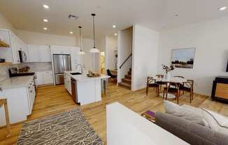an open kitchen and living room with a dining area and a table at Novella Biltmore, Arizona