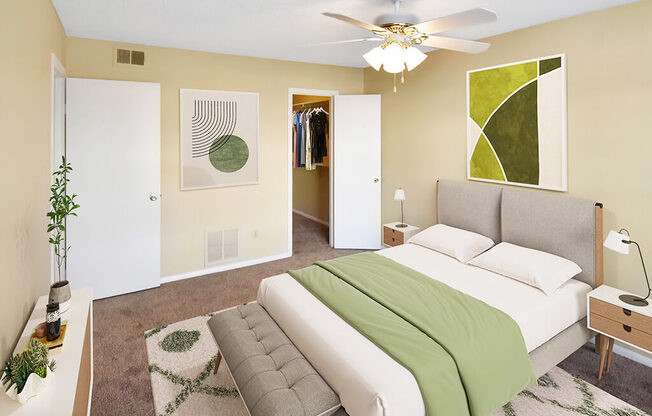 A bedroom with a bed, a couch, and a ceiling fan.