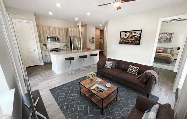 a living room and kitchen with a couch and a table