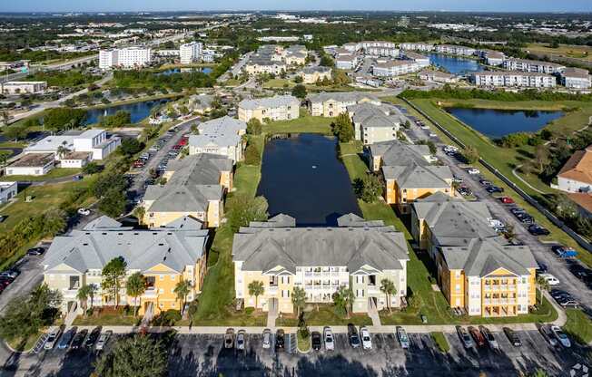 A large apartment complex with a lake in the middle.