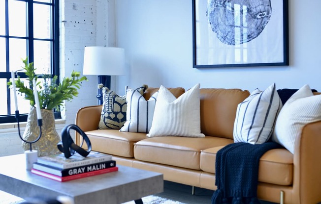a living room with a brown leather couch and a coffee table