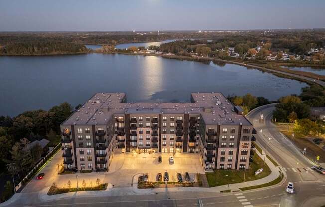 A large building with a parking lot in front of it.