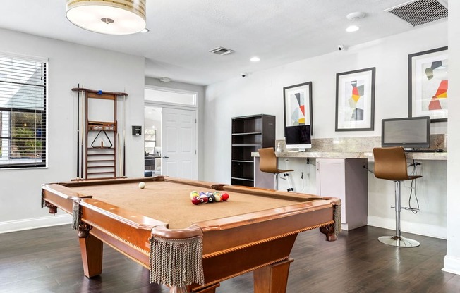 a pool table in a living room with a bar and a television at Waterford Park Apartment Homes, LLC, Lauderhill, 33319