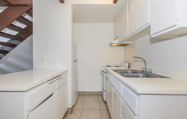 a white stove top oven sitting inside of a kitchen