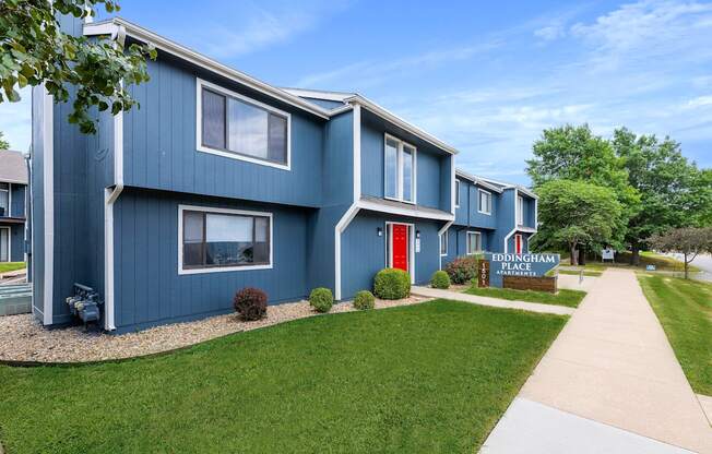 a blue building with a red door