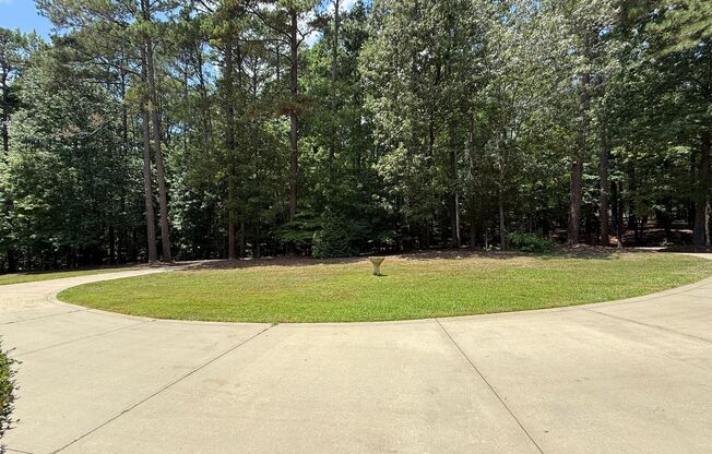 Tranquil and Secluded Raleigh Home with Unique Bonus Features Located on a 7+ Acre Lot on a Private Street with Plenty of Privacy and Outdoor Space