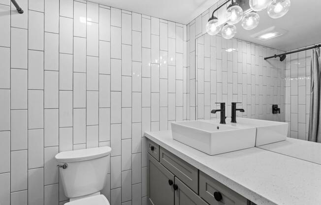 a bathroom with a toilet sink and a mirror