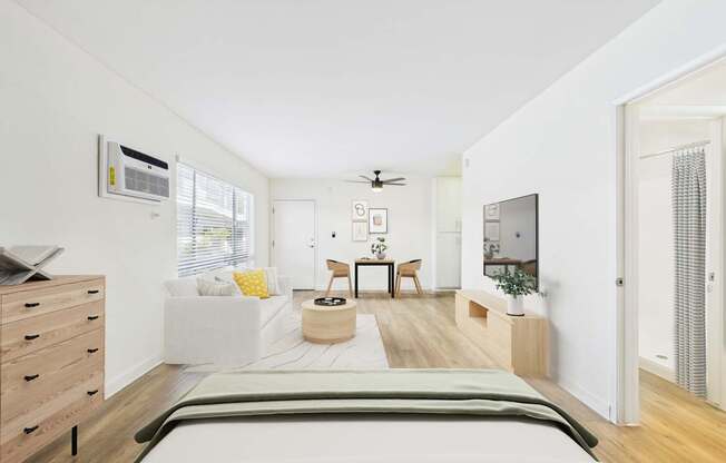 A bedroom with a bed, dresser, and a ceiling fan.