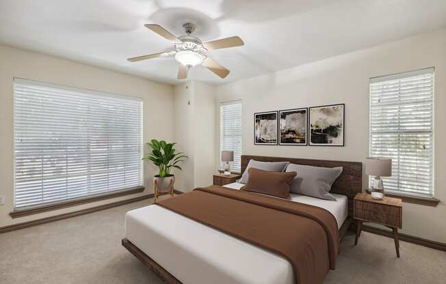 a bedroom with a bed and a ceiling fan