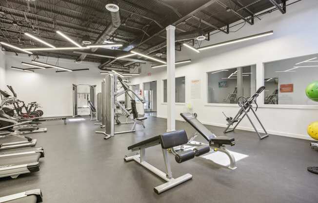 a gym with weights and other exercise equipment in a building