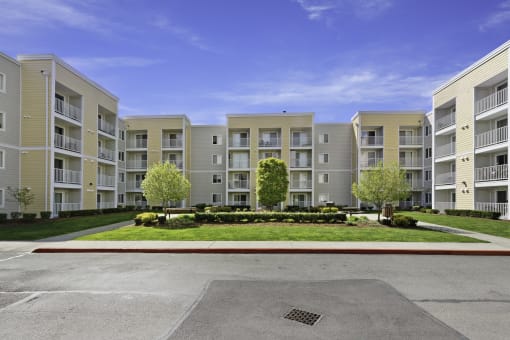 a picture of an apartment complex with a blue sky in the background  at Camelot Apartment Homes, Everett, Washington
