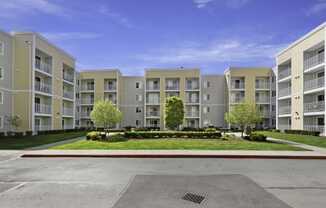 a picture of an apartment complex with a blue sky in the background  at Camelot Apartment Homes, Everett, Washington