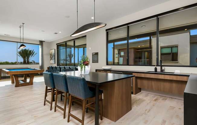 A modern kitchen with a pool table and bar area.