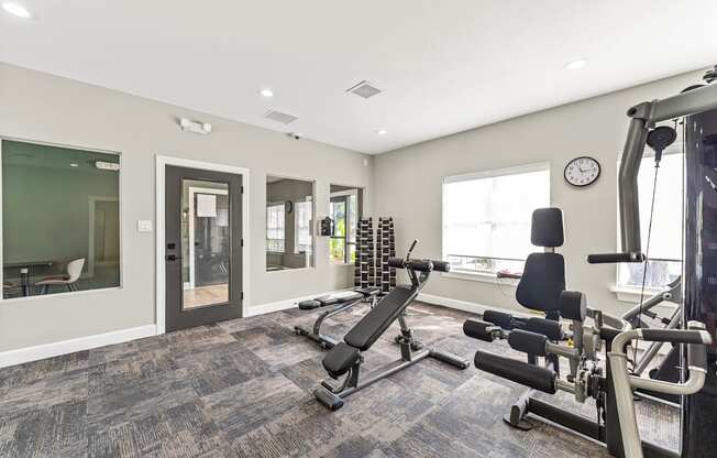 A spacious home gym with a variety of exercise equipment.