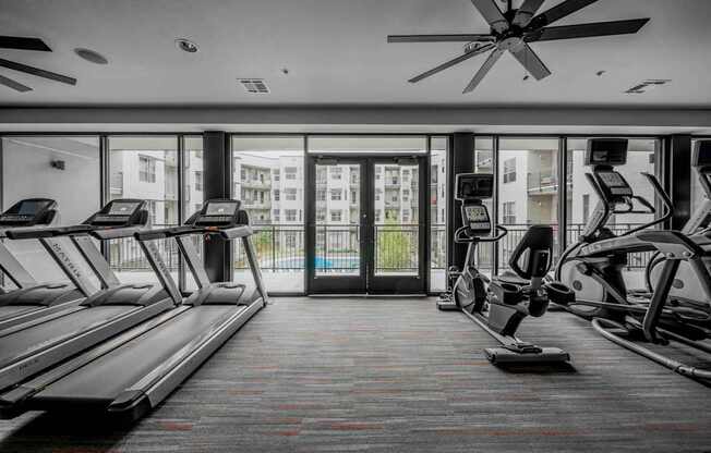 A gym with treadmills and elliptical machines at Regatta Sloans Lake Apartments, Denver, CO