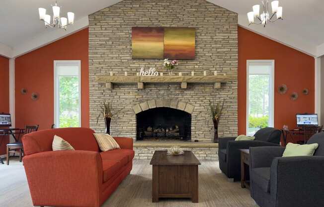 A living room with a fireplace and a painting above it.