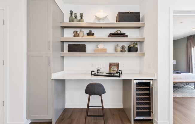 a small desk with a chair in a room with shelves