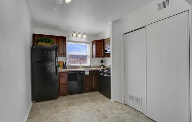 Apartments in Williamsport | Woodland Park |a kitchen with a black refrigerator freezer next to a window