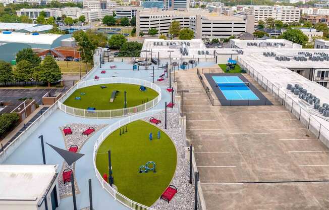 A playground with a blue pool and a slide.